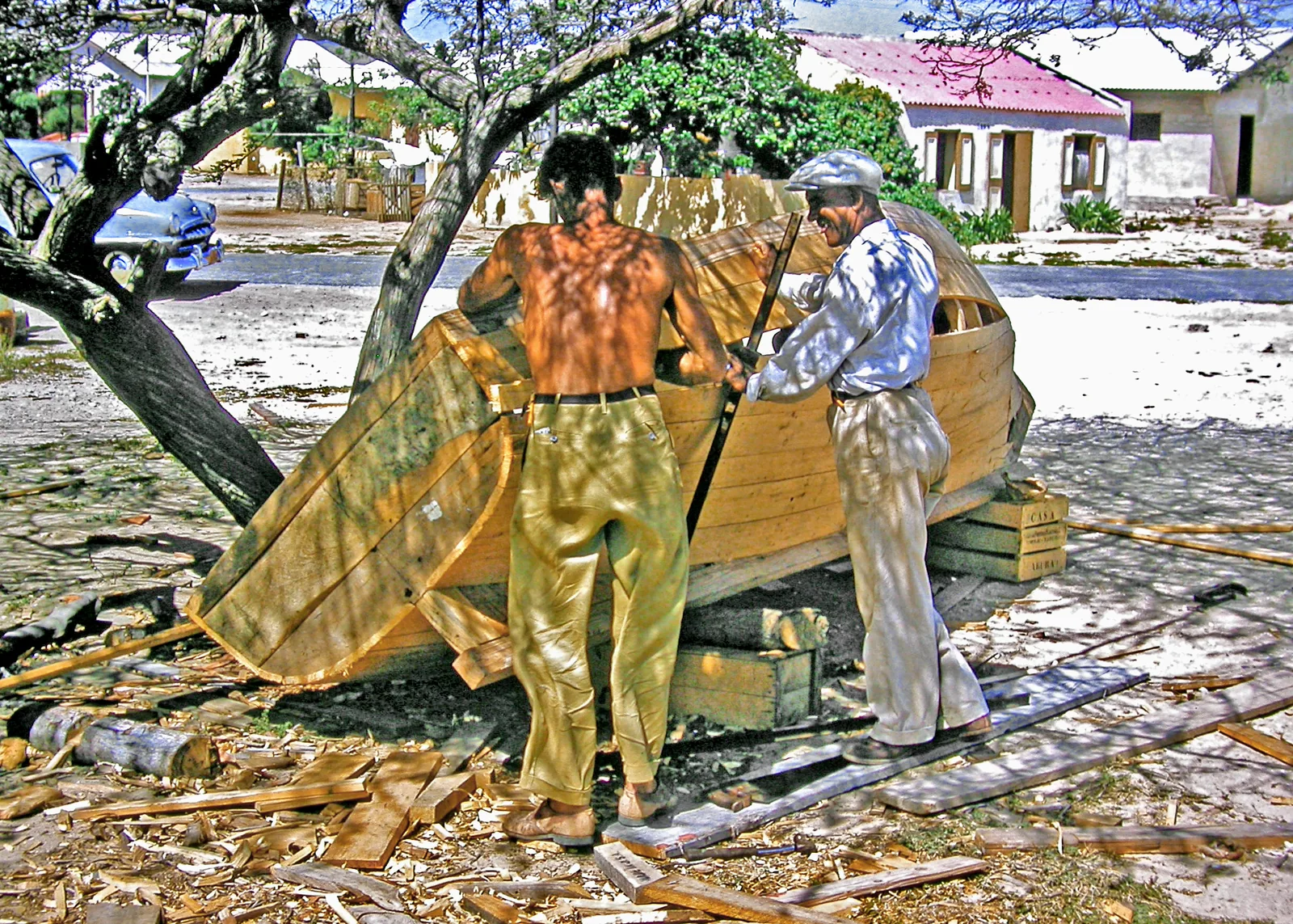 Boat builders at work on a wooden fishing boat in Savaneta, Aruba, in 1958